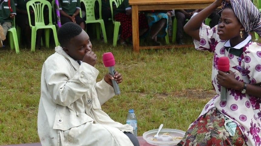 A drama group performing at a community gathering A drama group performing at a community gathering
